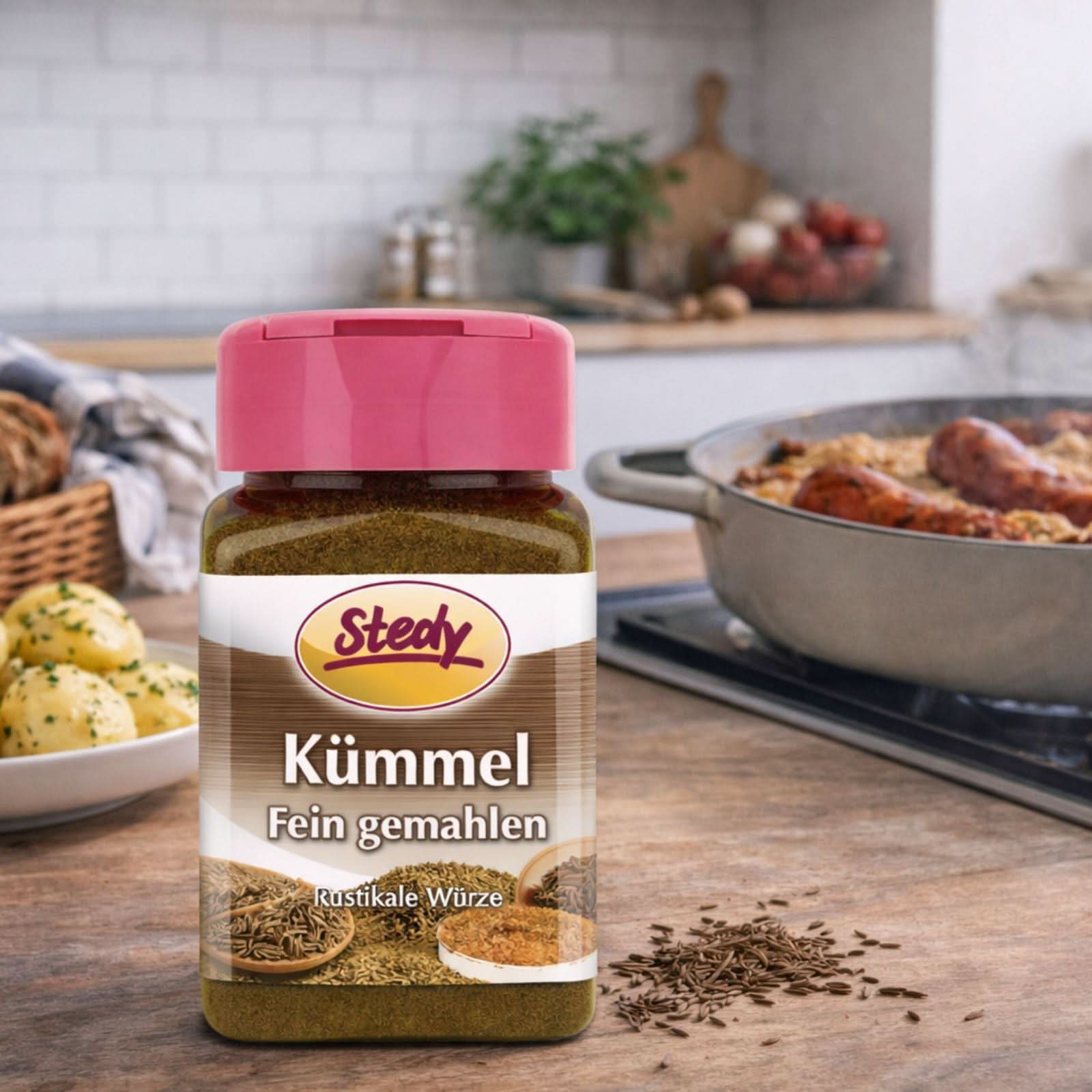 Kümmel gemahlen im Streuer in Küchenszene neben Pfanne und Gewürzen